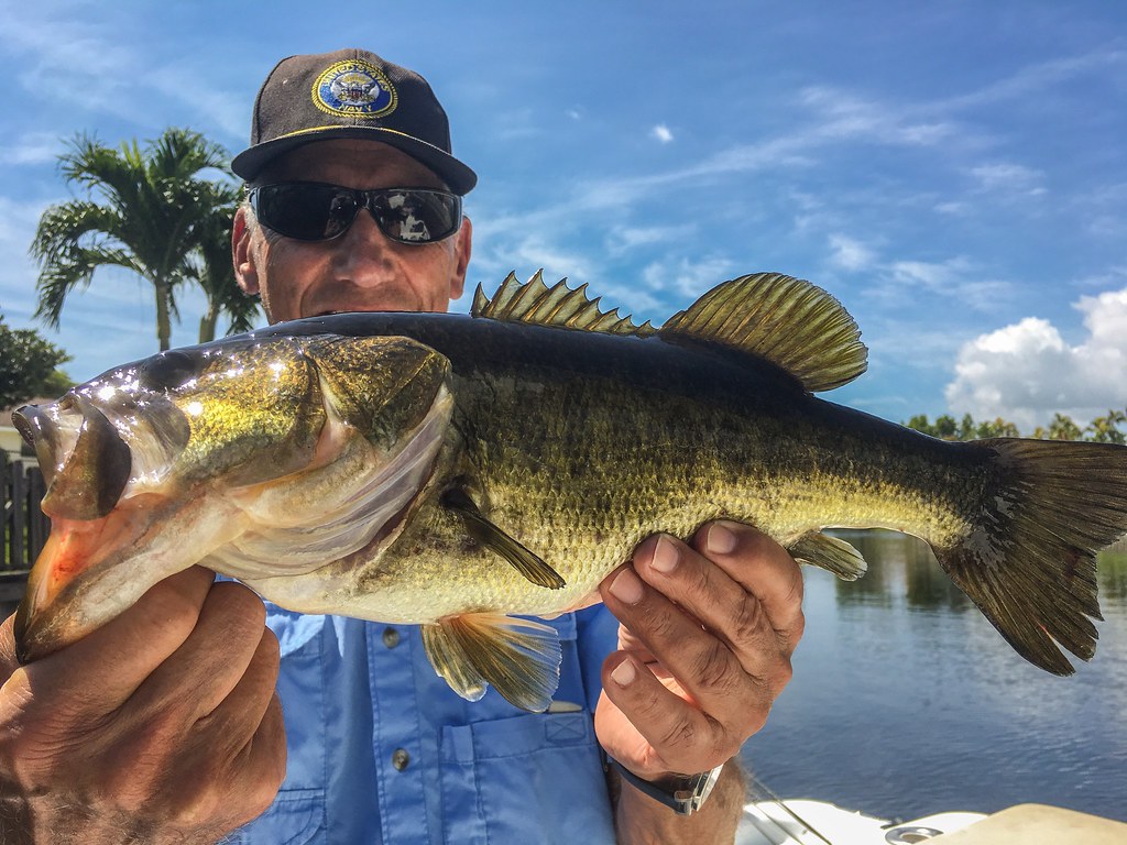 Man holding a large fish — the classic swipe-left dating photo